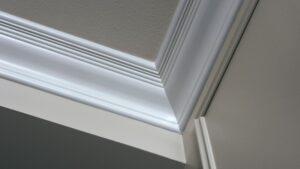 Painted crown molding along the ceiling line of a living room